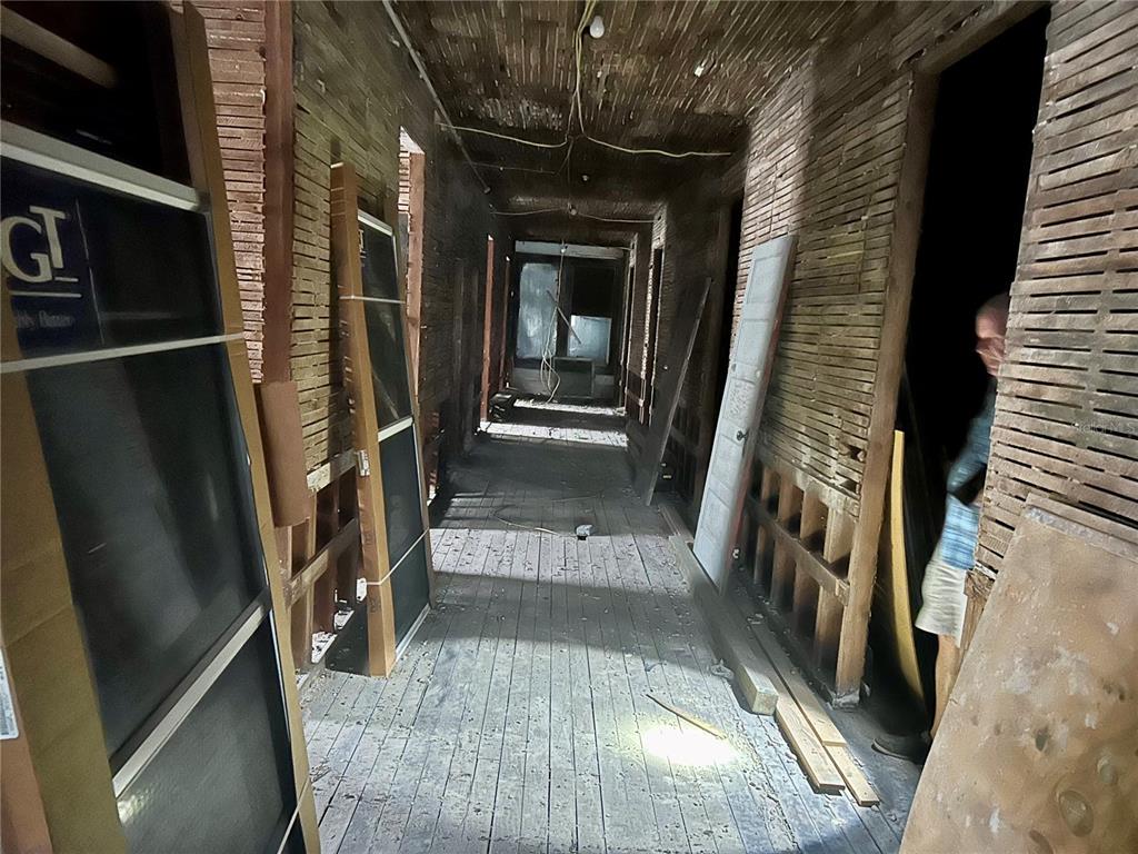 208 West Main Street Wauchula, FL 33873 - Photo 28 of 36 a view of a hallway with wooden floor and glass door