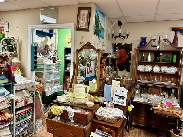 a work room with lots of furniture and a wooden floor