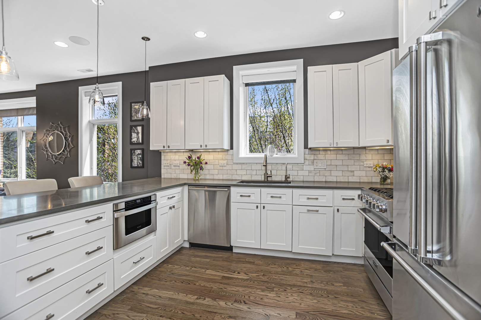 2301 West Wolfram Street, Unit 2 Chicago, IL 60618 - Photo 11 of 26 a kitchen with stainless steel appliances granite countertop a stove a sink and a refrigerator