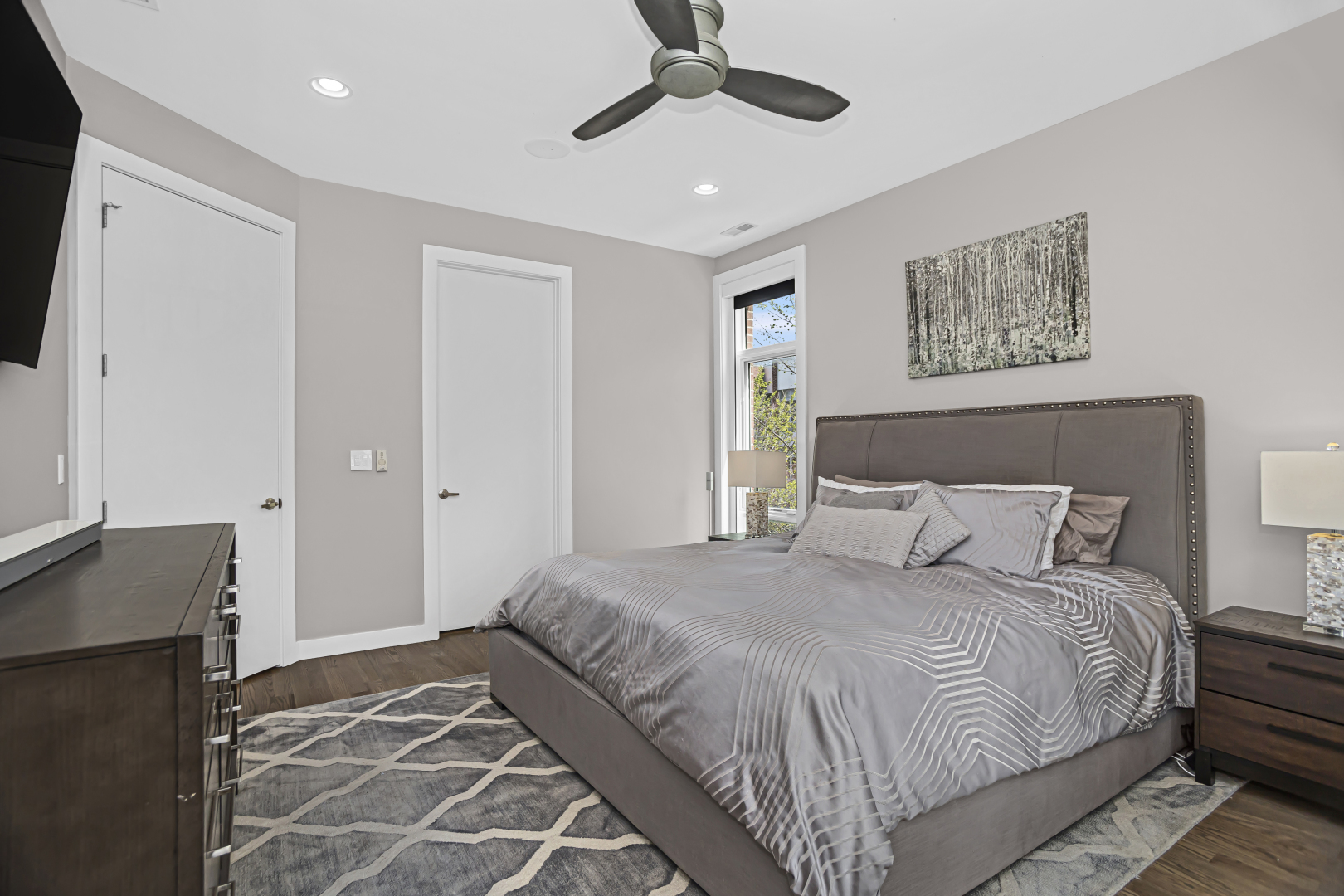 2301 West Wolfram Street, Unit 2 Chicago, IL 60618 - Photo 15 of 26 a bedroom with a large bed and a flat screen tv