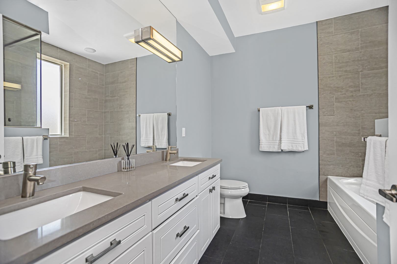 2301 West Wolfram Street, Unit 2 Chicago, IL 60618 - Photo 18 of 26 a bathroom with a double vanity sink and a mirror