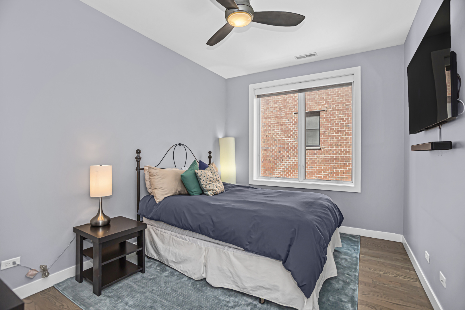 2301 West Wolfram Street, Unit 2 Chicago, IL 60618 - Photo 19 of 26 a bedroom with a bed window and a flat screen tv