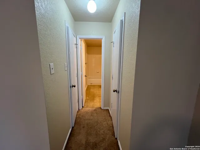 a view of a hallway with a livingroom