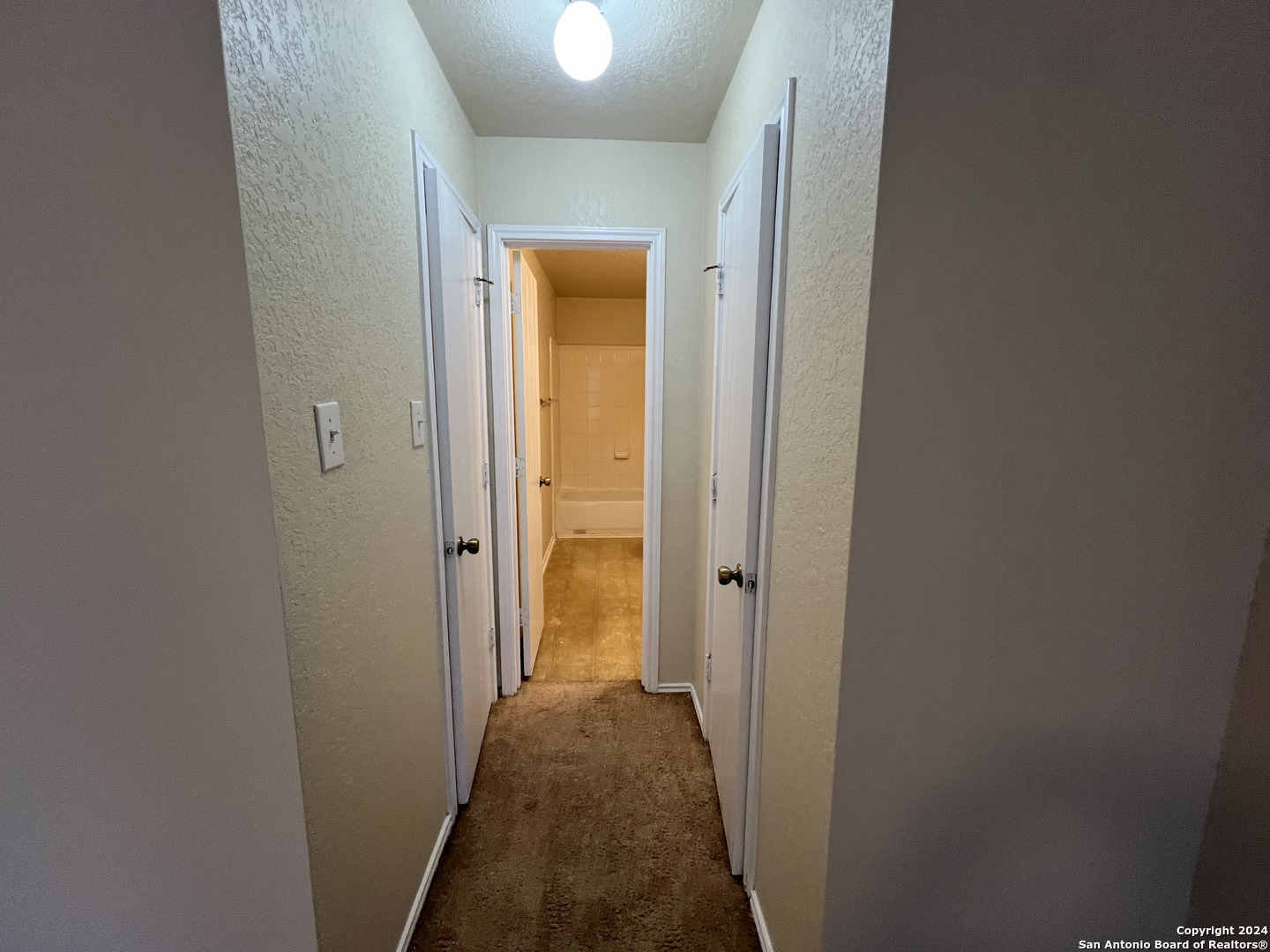 10118 Figaro San Antonio, TX 78260 - Photo 14 of 20 a view of a hallway with a livingroom