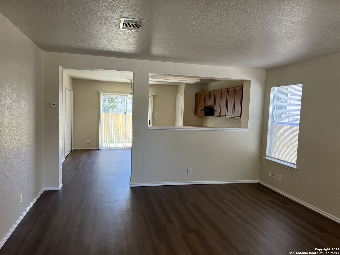 10118 Figaro San Antonio, TX 78260 - Photo 2 of 20 an empty room with wooden floor and windows