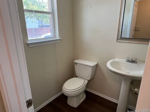 a white toilet sitting next to a bathroom sink