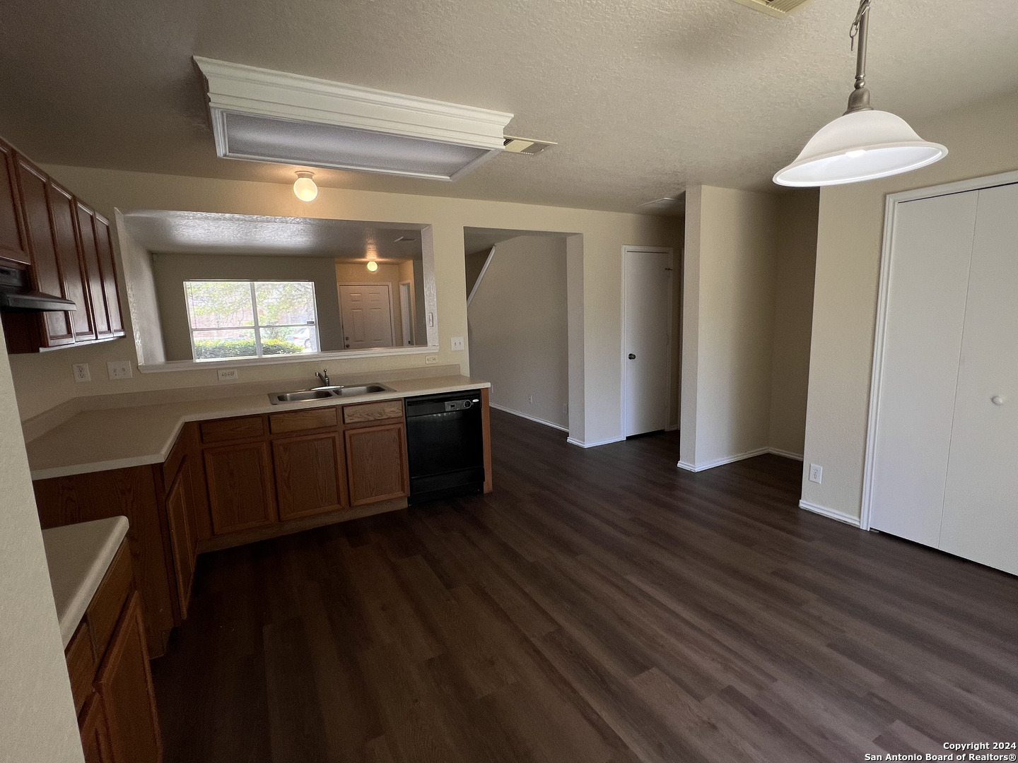 10118 Figaro San Antonio, TX 78260 - Photo 6 of 20 a kitchen with stainless steel appliances granite countertop a sink a stove a refrigerator and island with wooden floor