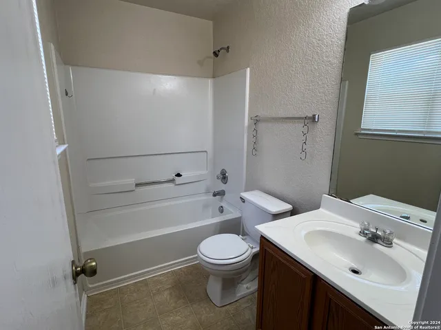 a bathroom with a sink toilet tub and shower