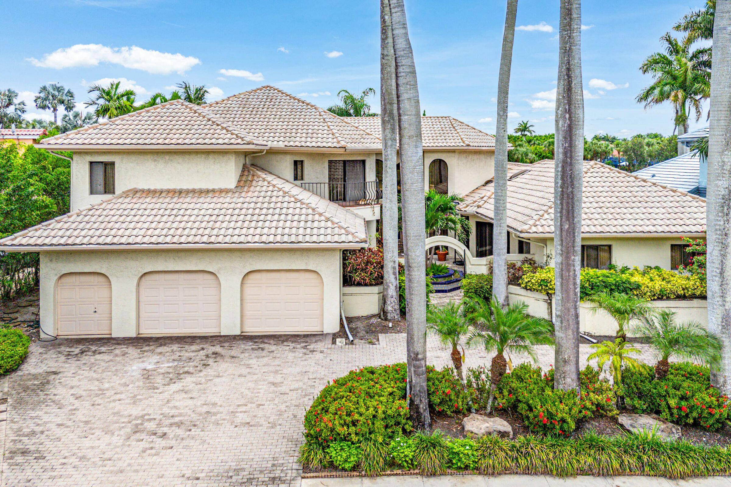 7339 Mandarin Drive Boca Raton, FL 33433 - Photo 2 of 47 a front view of a house with garden