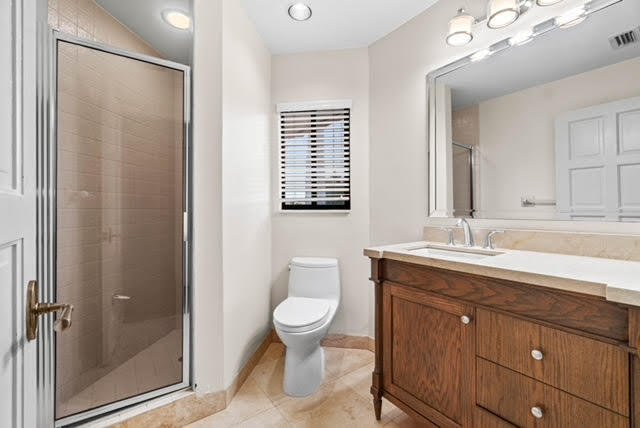 7339 Mandarin Drive Boca Raton, FL 33433 - Photo 36 of 47 a bathroom with a granite countertop sink toilet and shower