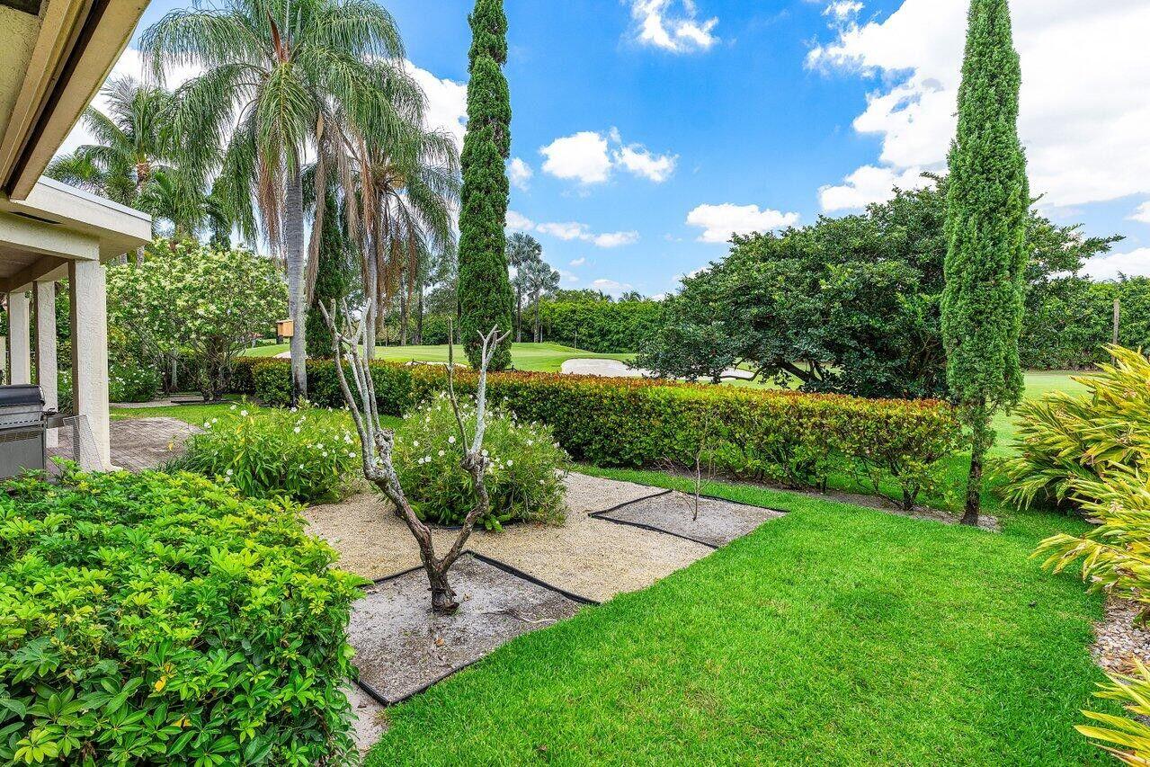 7339 Mandarin Drive Boca Raton, FL 33433 - Photo 46 of 47 a view of a garden with a bench