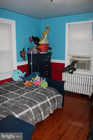 a bedroom with two beds and a potted plant