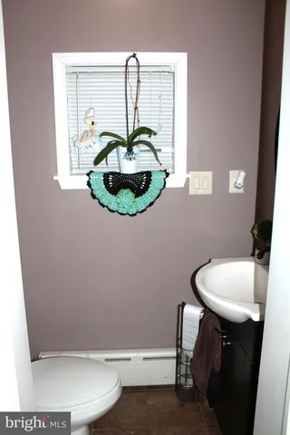 a bathroom with a sink toilet and mirror