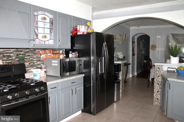 a kitchen with stainless steel appliances granite countertop a refrigerator and a stove