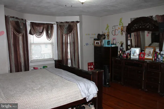 a bed sitting in a bedroom next to a window