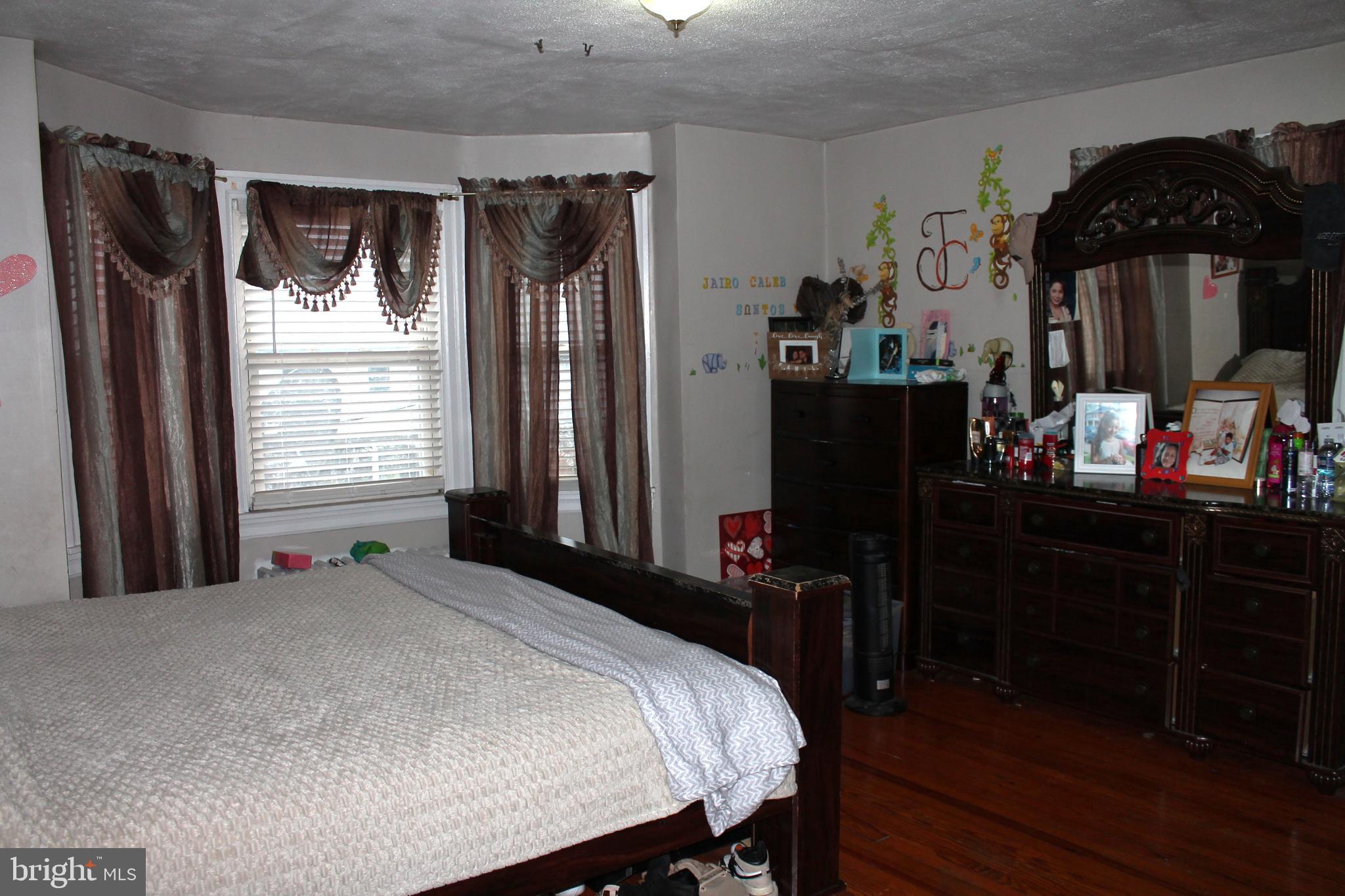 3431 Fairfield Street Reading, PA 19605 - Photo 10 of 15 a bed sitting in a bedroom next to a window