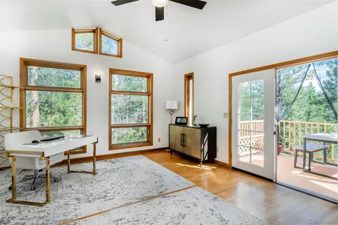 a living room with furniture and large windows