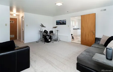 a living room with furniture gym equipment and a view of bedroom