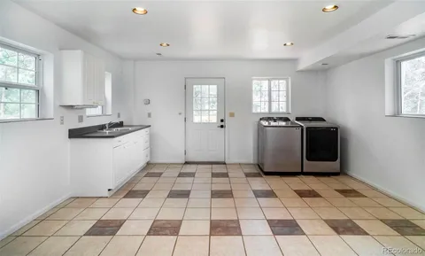 a kitchen with a sink a stove cabinets and counter space