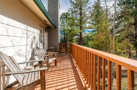 a balcony with wooden floor and fence