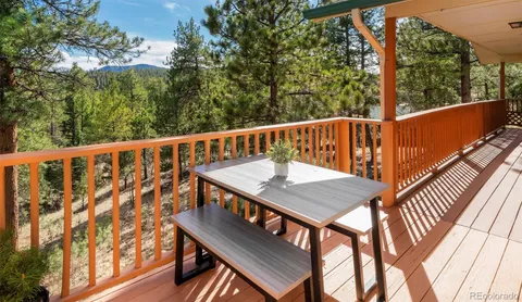 a view of a balcony with wooden floor and outdoor seating