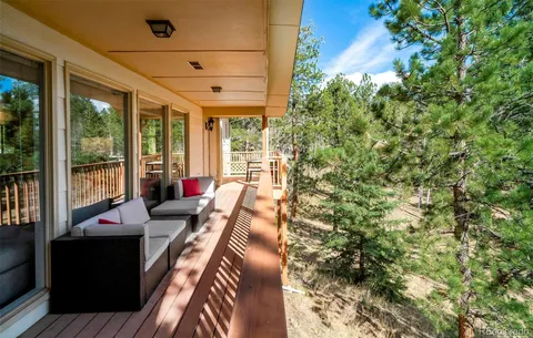 a view of a living room and balcony