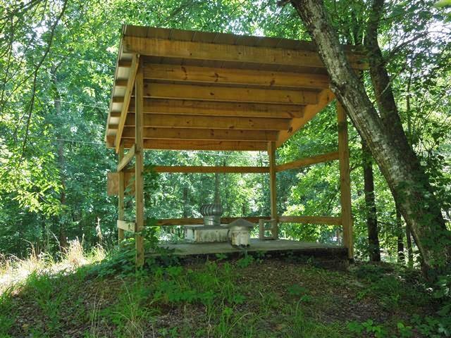 680 Edenway Road Dover, TN 37058 - Photo 6 of 20 Amazing storm cellar - lift-up top, step down ladder, serviced with electric & emergency lights, waterline, TV hookups, & 2 bunk beds! Metal roof covers the concrete top of the storm cellar!