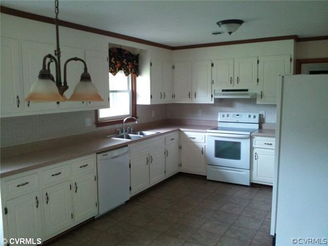 19705 Carson Ruritan Road Carson, VA 23830 - Photo 4 of 7 a kitchen with cabinets appliances a sink and a window