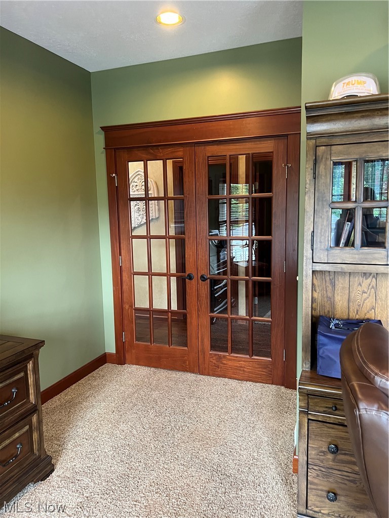 1457 Terrace Road Northwest New Philadelphia, OH 44663 - Photo 16 of 33 Entryway with carpet and french doors