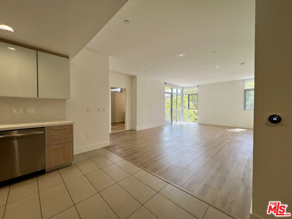 11715 Bellagio Road, Unit 204 Los Angeles, CA 90049 - Photo 3 of 27 a view of an empty room with window and cabinet