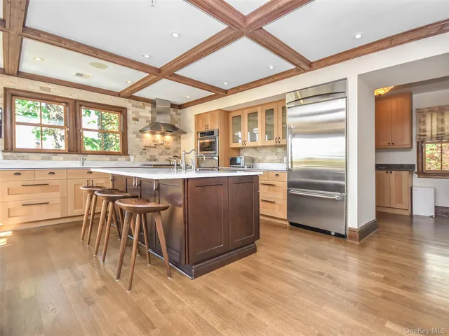 a kitchen with stainless steel appliances granite countertop a stove and a refrigerator