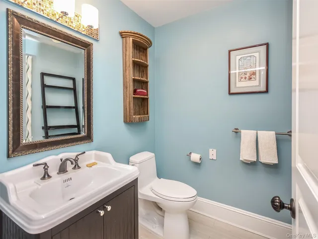 a bathroom with a toilet sink and mirror