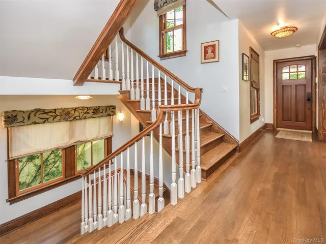 a view of staircase with wooden floor and white walls