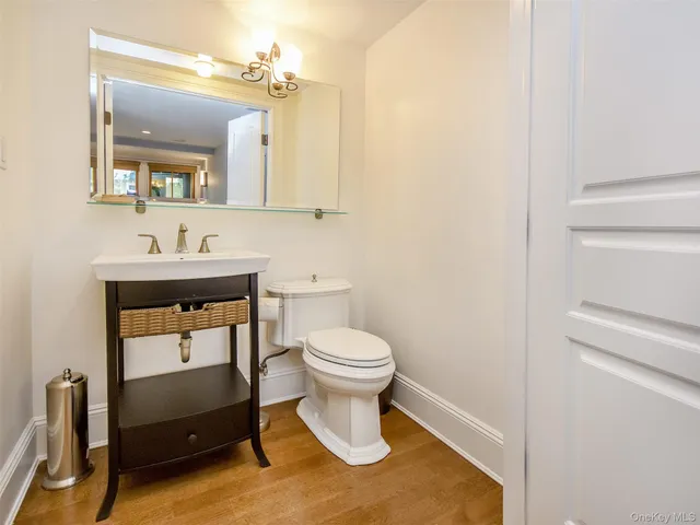 a bathroom with a sink a toilet and mirror