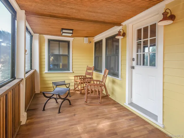 a view of a patio with table and chairs and wooden floor