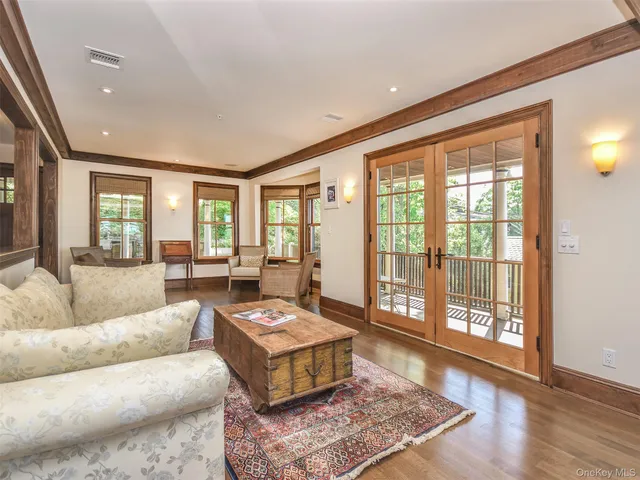 a living room with furniture and a floor to ceiling window