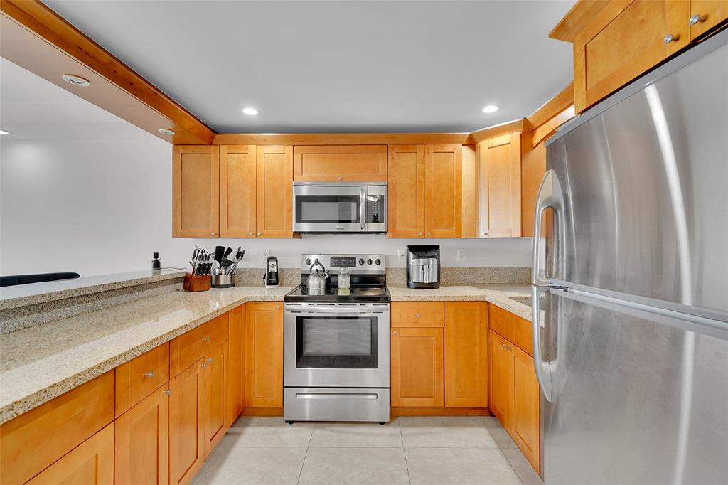 400 North Surf Road, Unit 703 Hollywood, FL 33019 - Photo 18 of 50 a kitchen with a sink appliances cabinets and a counter top space
