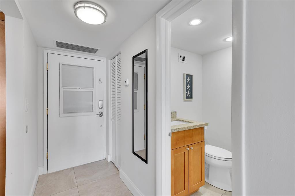 400 North Surf Road, Unit 703 Hollywood, FL 33019 - Photo 24 of 50 a bathroom with a toilet sink and a mirror