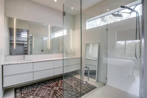 a bathroom with a double vanity sink and a mirror