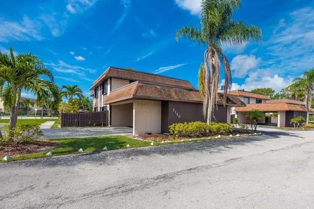 a front view of a house with a yard and a garage