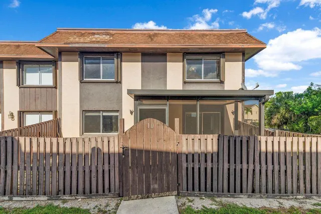 a front view of a house with a fence