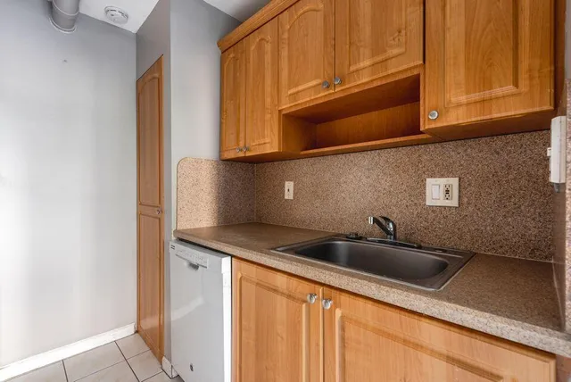a kitchen with stainless steel appliances granite countertop a sink and cabinets