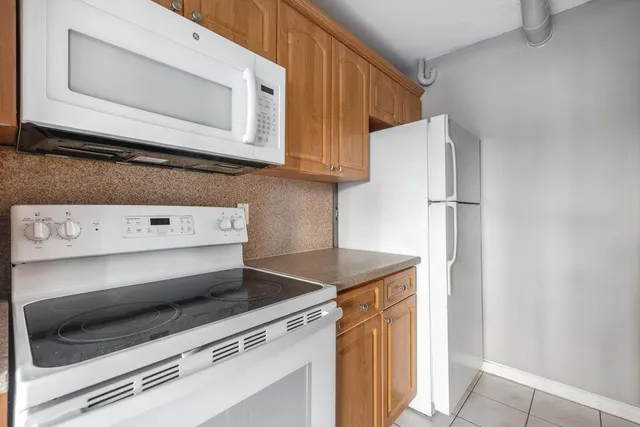 a stove top oven sitting inside of a kitchen