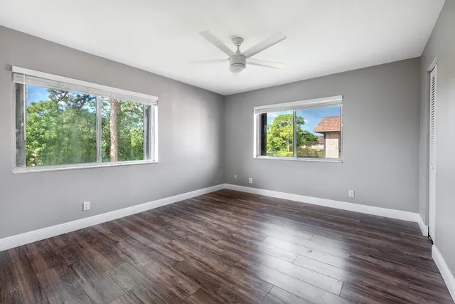 a view of an empty room with wooden floor