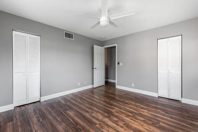 a bathroom with a granite countertop sink mirror toilet and bathtub