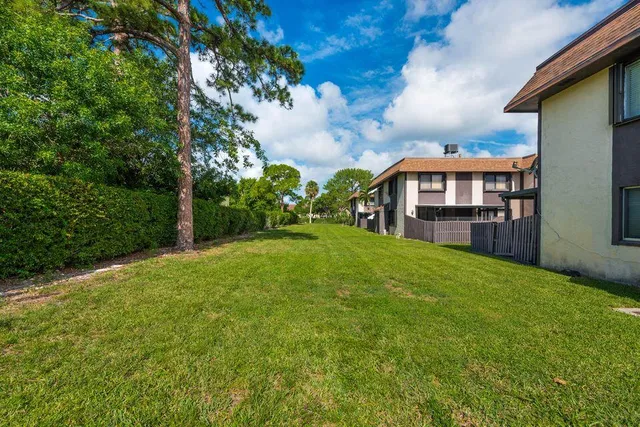 a view of a house with a yard and sitting area