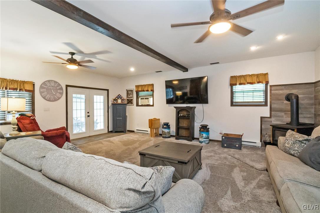 115 Pine Cove Court Lehighton, PA 18235 - Photo 36 of 49 a living room with furniture ceiling fan and a flat screen tv