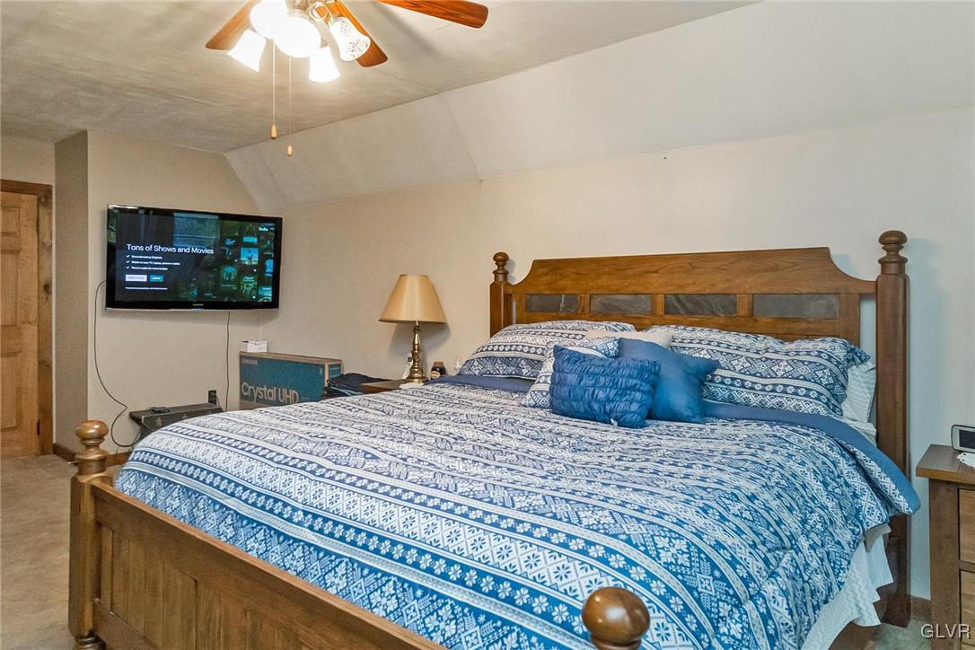 115 Pine Cove Court Lehighton, PA 18235 - Photo 44 of 49 a bedroom with a large bed and a flat screen tv