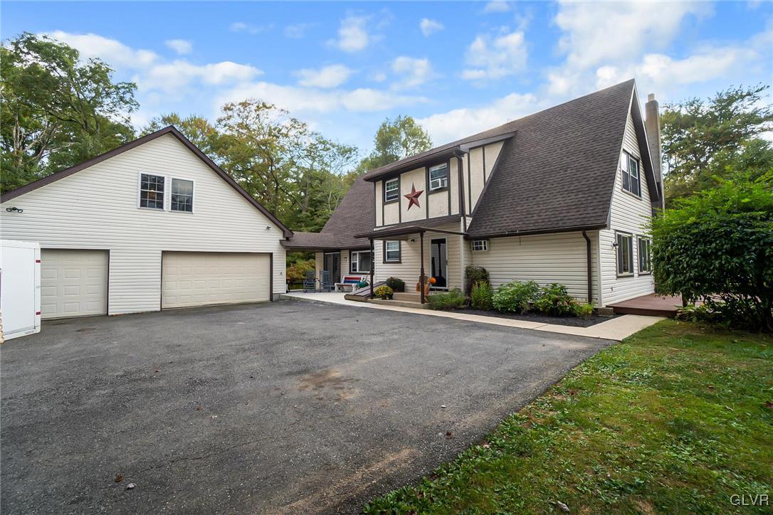 115 Pine Cove Court Lehighton, PA 18235 - Photo 9 of 49 a front view of a house with a garden and trees