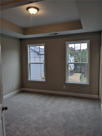 an empty room with a empty space and windows
